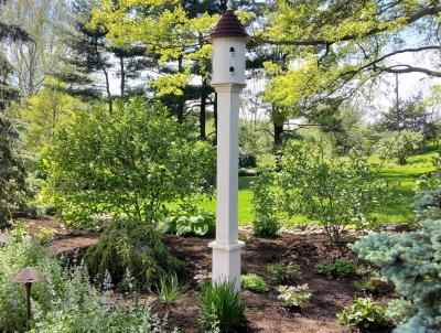A stunning birdhouse adds a pop of interest to the area. A stunning birdhouse adds a pop of interest to the area.