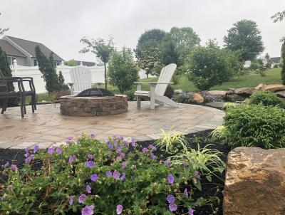 Landscaping around a small patio with firepit. Landscaping around a small patio with firepit.