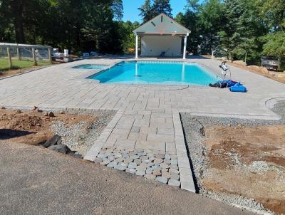 A pool deck in progress using pavers.