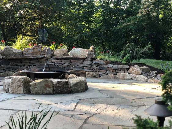 PA Irregular Flagstone upper patio, boulder fire pit ring, retaining wall and sitting walls.