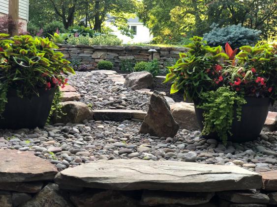 Decorative river rock adds aesthetic value as well as minimizing runoff during heavy rains.