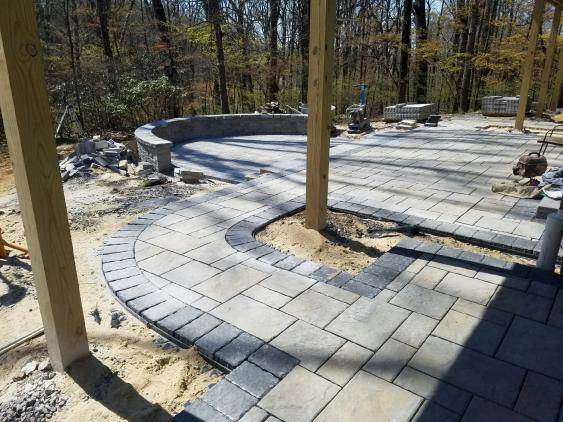Current installation in Wayne of a patio with a deck above.