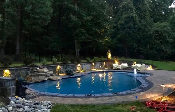 A finished project with pavers surrounding the pool.