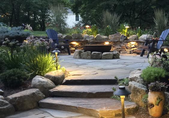 Pottstown flagstone patio and firepit surrounded by boulders.