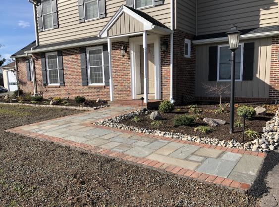 Natural cleft pattern flagstone with brick border recently installed.