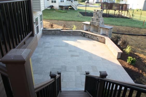 This large rectangular patio features Kennedy Blue Mountain pavers, a great sitting wall and a fireplace.