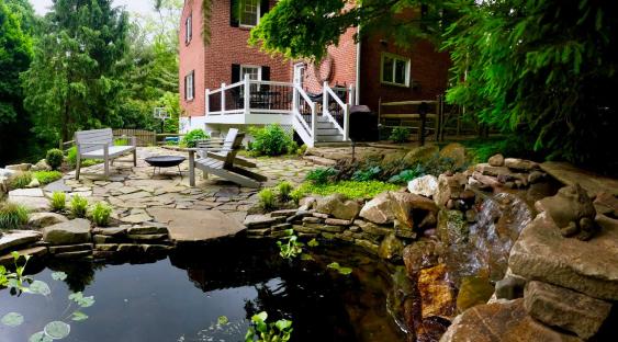 Pond and waterfall create a peaceful oasis for flagstone patio in Wayne.