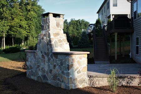 Backview stone veneer outdoor fireplace in Skippack, PA