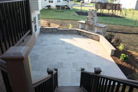 This Harleysville, Pa spacious paver patio includes an outdoor fireplace and sitting wall for entertaining.