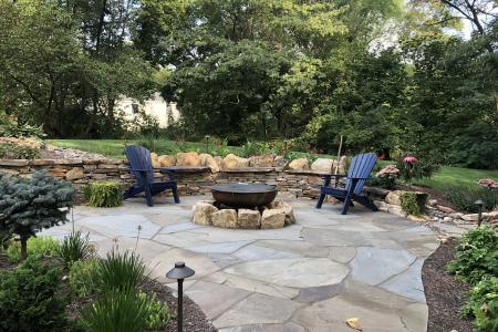 Pottstown Irregular Flagstone Patio with fire pit and natural stone walls.