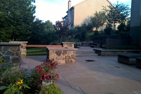 Patio in Pottstown, PA with fire pit, stone bench and chairs