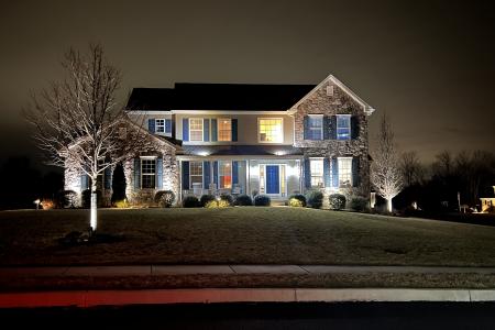Low voltage landscape lighting highlights Schwenksville home and landscaping features.