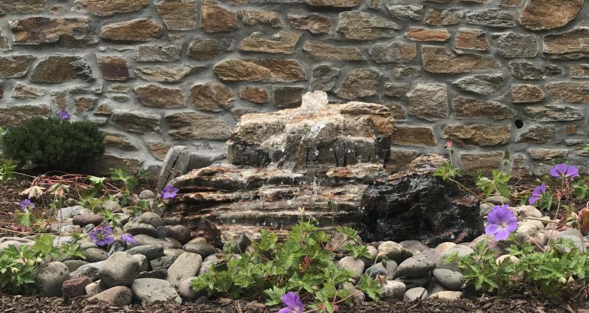 Boulder water fountain installed in a Schwenksville backyard