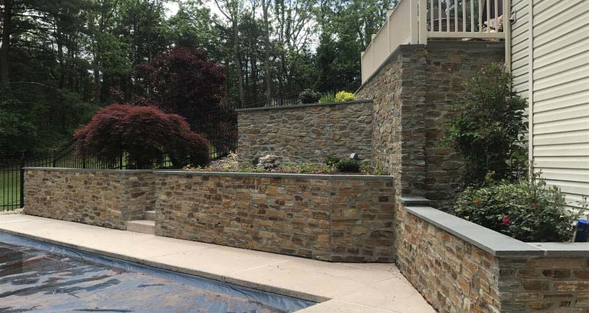 Veneer retaining walls surrounding a beautiful pool in Schwenksville, PA