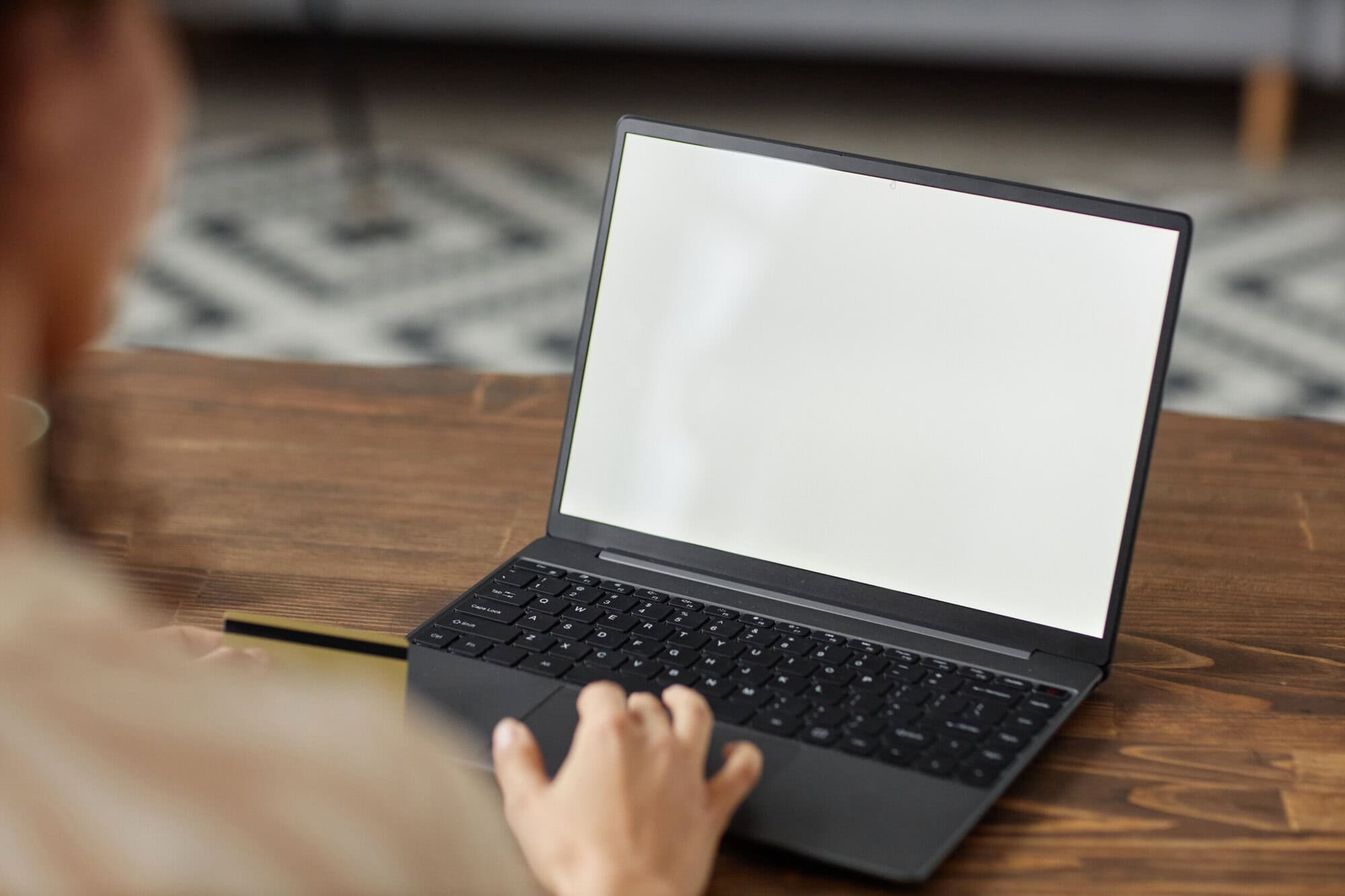 A Person Sitting at a Desk with a Laptop and a Credit Card Free Stock Photo by Everypixel