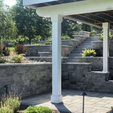 Techo- Bloc Mini-Creta tiered retaining wall allows access to a new patio area.